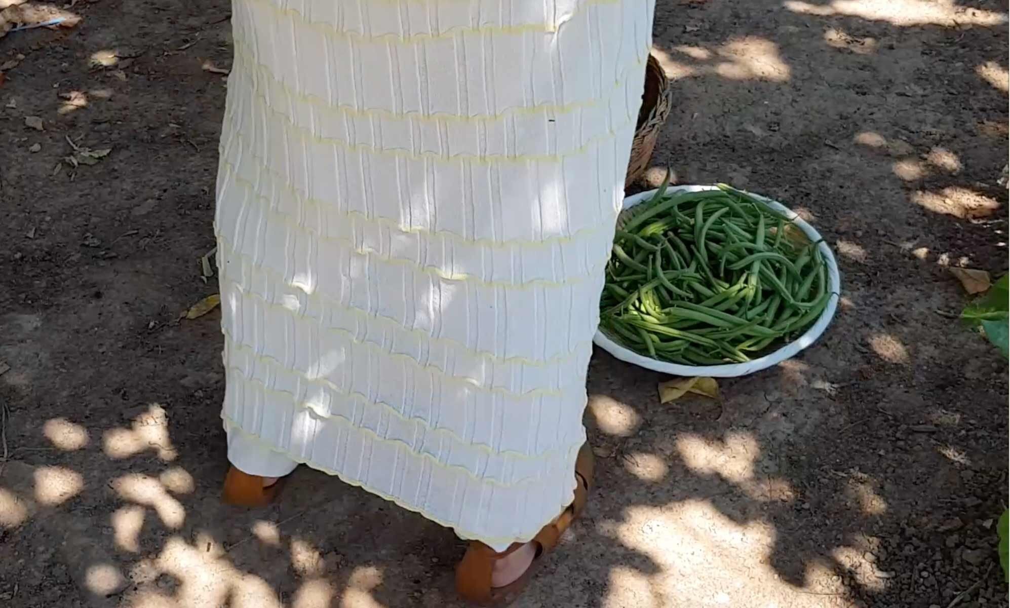Johanna during the harvest wearing the Comète dress in Chalk/ Butter .Filmed by Juliette Riegel.