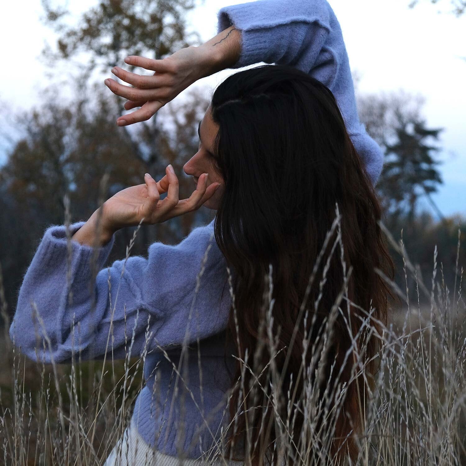 Charlotte’s self-portrait wearing the KIRUTO sweater in Lavender and the NAIFU pants in Chalk.