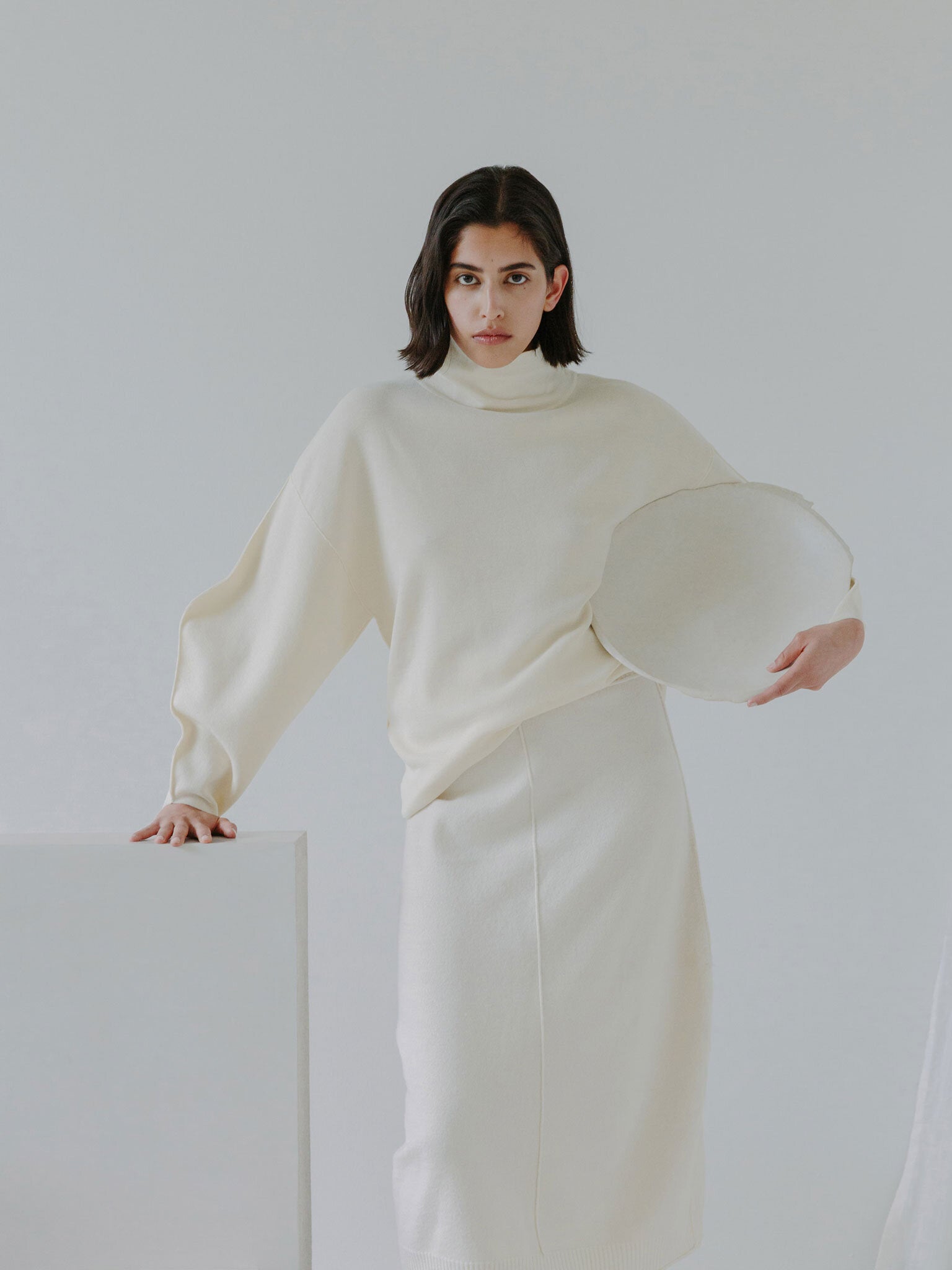 Esra wearing the KOPPU sweater and KOSAJI skirt with chair N04F002 and Moon Bowl N02002. Photographed by Marina Denisova.