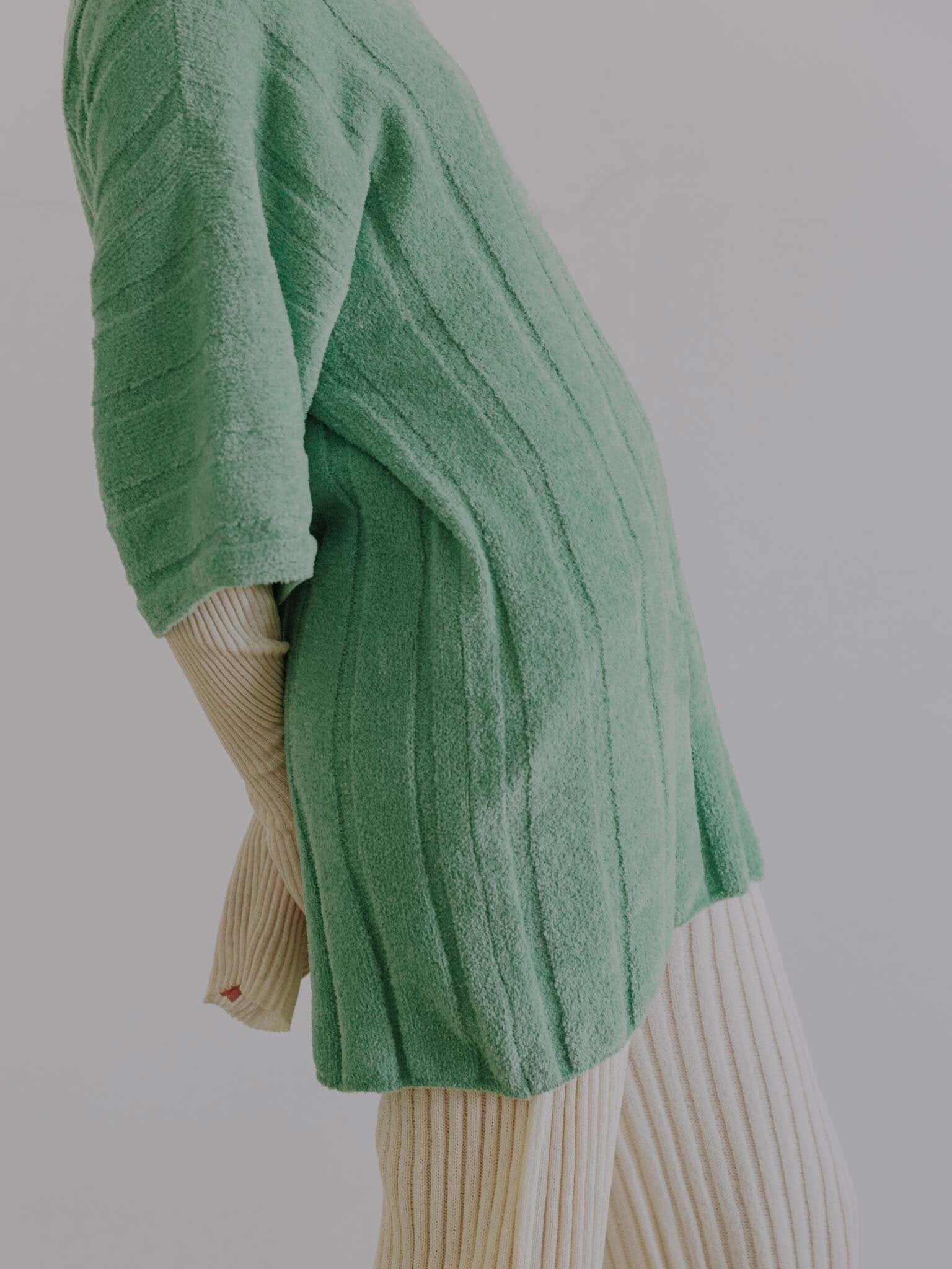 ROSÉE polo in Matcha, NIWA sweater and KYANDORU pants in Eggshell.